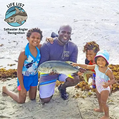 Florida family with Jack Crevalle fish on the beach.