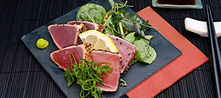 Seared ahi (tuna) on plate at restaurant.
