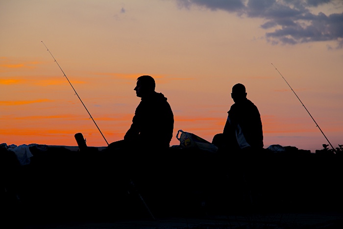 Fishing at night with a buddy is safer and more fun.