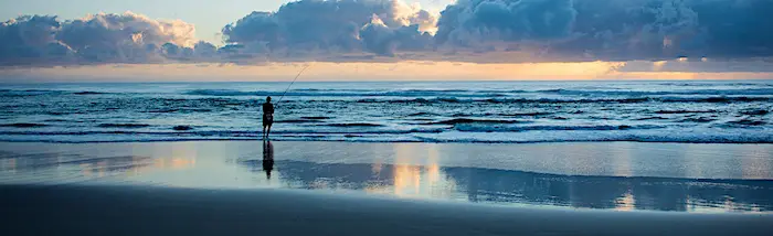 Surf fishing in Florida from the beach on a cool morning.