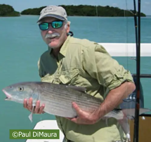 Bob Shroeder holds the biggest bonefish ever caught in Florida State before he releases it.