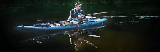 Kayak fishing on flat ocean water.