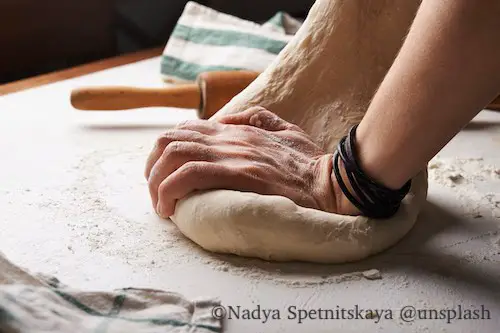 Making bread dough, kneading the heavy dough which is ideal for baiting fishing hooks.