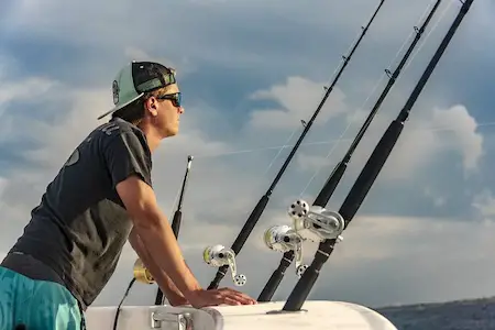 Four saltwater trolling rods and reels on a deep-sea fishing boat on the Gulf of Mexico off Florida Coast.