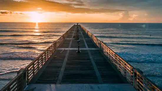Jacksonville Beach Fishing Pier at sunrise showing the length and width of it. 